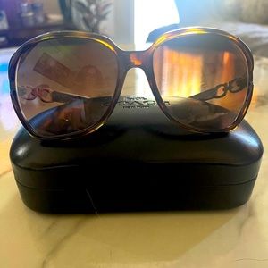 Brown /tortoise color Authentic Coach sunglasses with black coach case .
